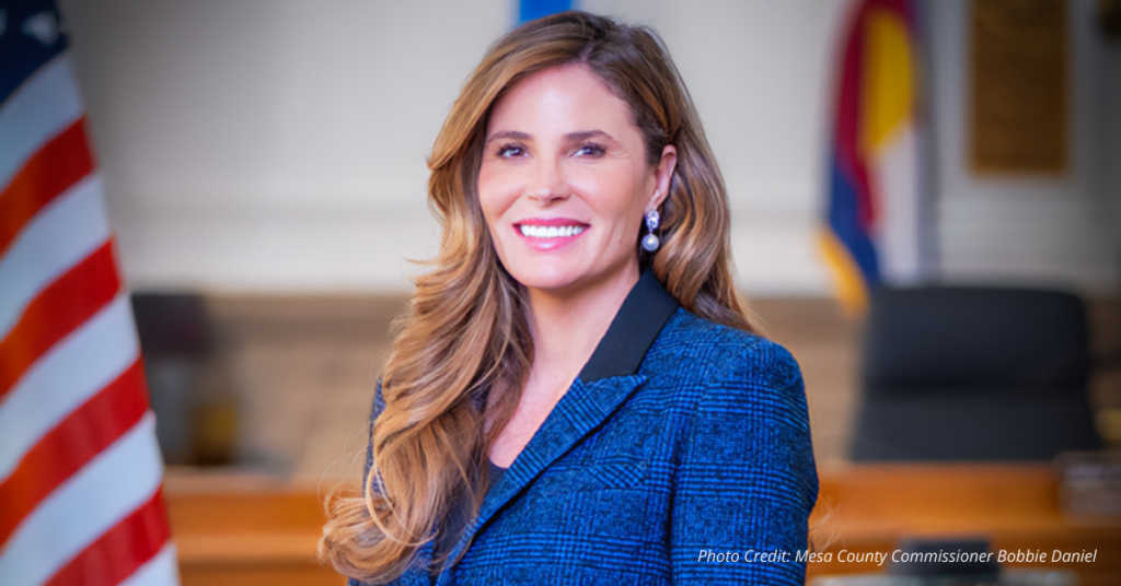 Bobbie Daniel in a formal setting, calling for common sense budgeting and local control in Colorado