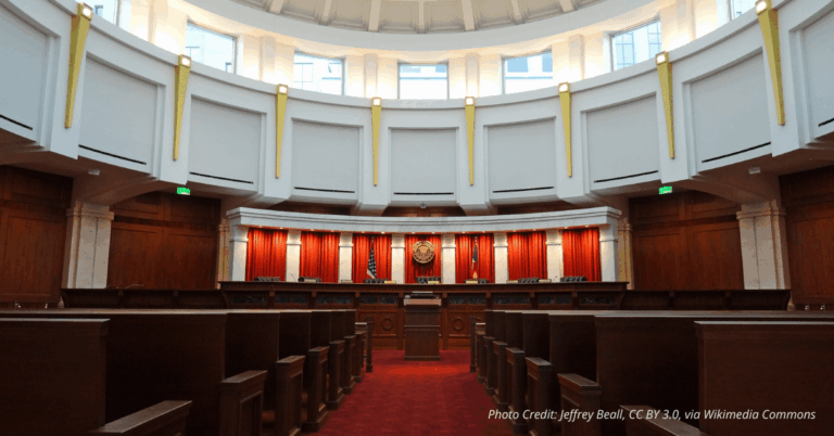 Colorado Supreme Court courtroom chamber with judicial bench and state seal, symbolizing state-level judicial authority