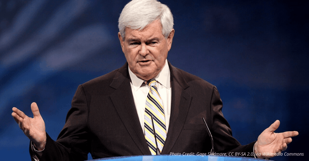 Newt Gingrich speaks at CPAC with American flags in the background