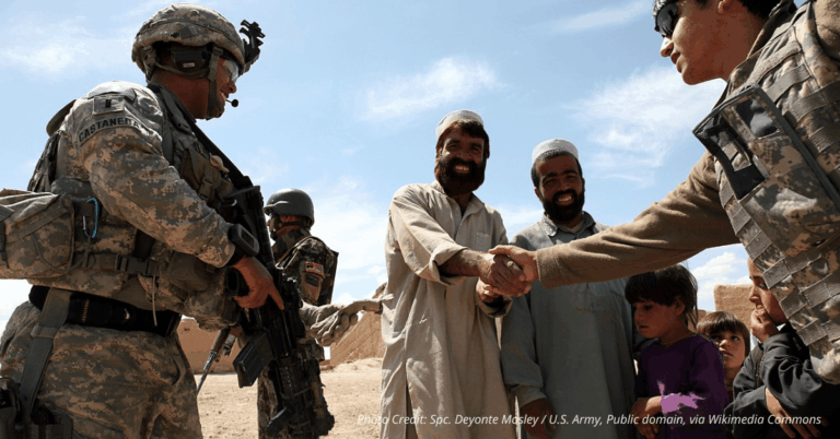 U.S. soldiers meet with Afghan villagers during joint patrol in Bidak, symbolizing alliance and shared mission
