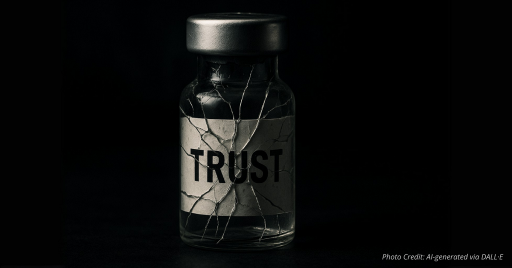 Cracked vaccine vial labeled ‘Trust’ representing fragile faith in science