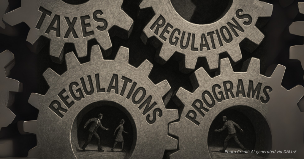 Oversized gears labeled Taxes, Regulations, Programs with small people in between