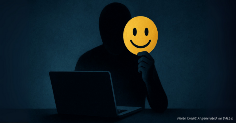 Shadowy figure holds smiling emoji mask behind screen