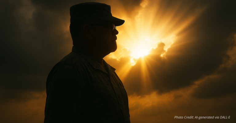 Silhouette of a soldier at attention with golden light breaking through clouds
