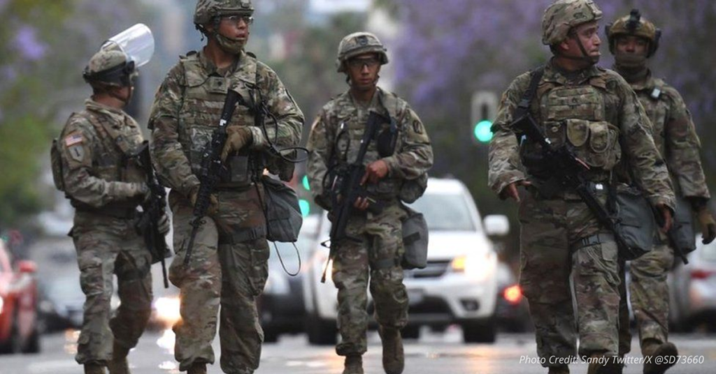 National Guard soldiers patrol city streets with weapons ready