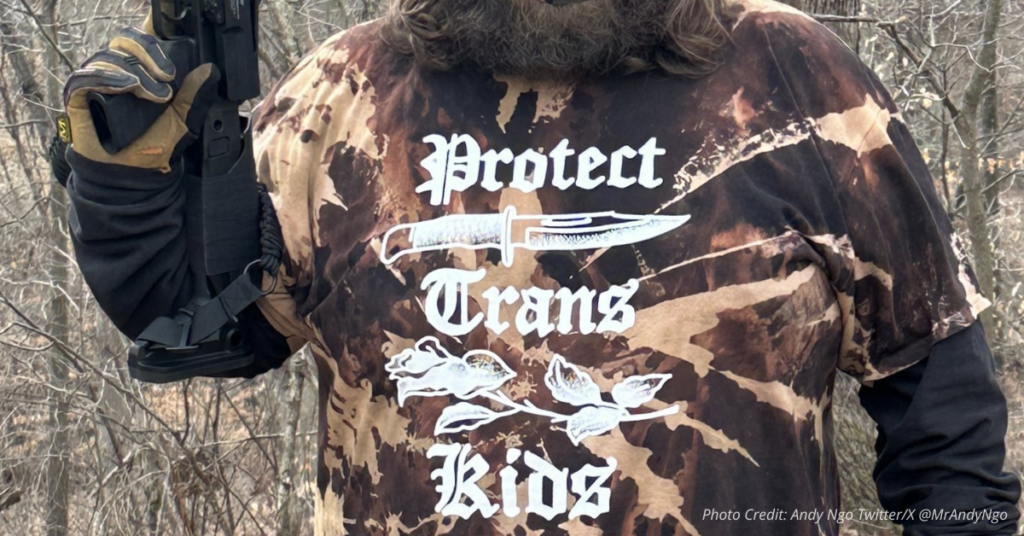 Masked person in ‘Protect Trans Kids’ shirt holding rifle, symbolizing violent trans propaganda