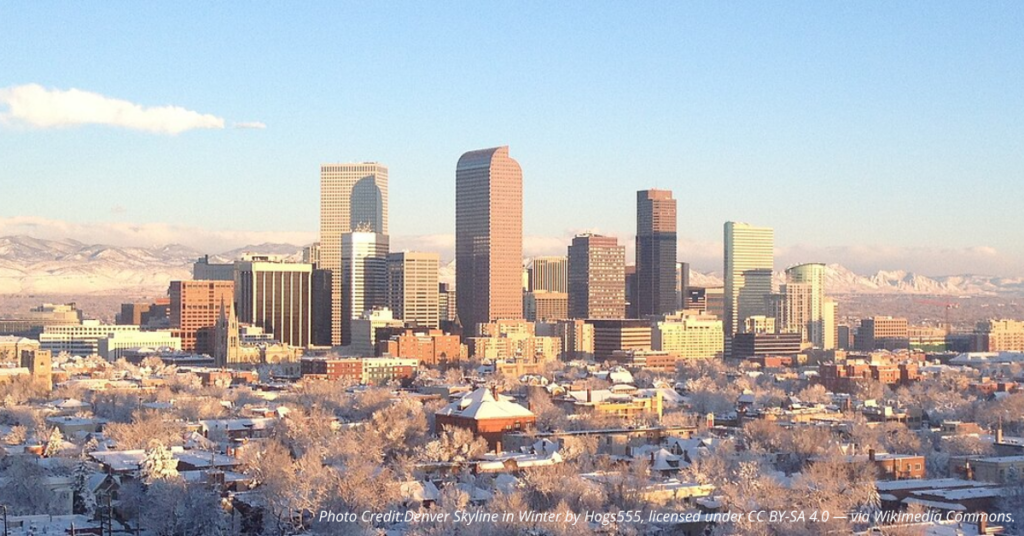 Denver skyline in winter with snow-covered mountains in the background