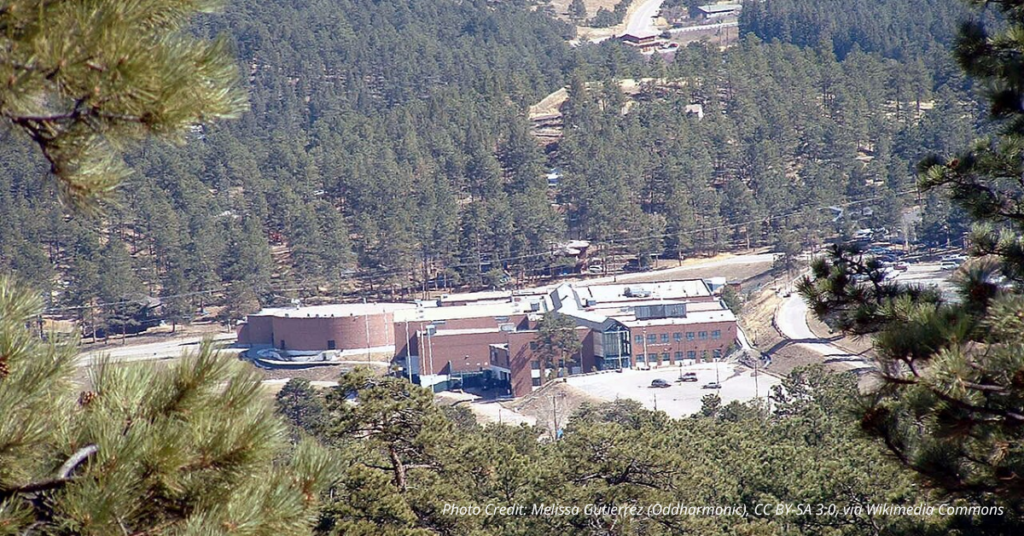 Evergreen High School surrounded by forested hills in Colorado