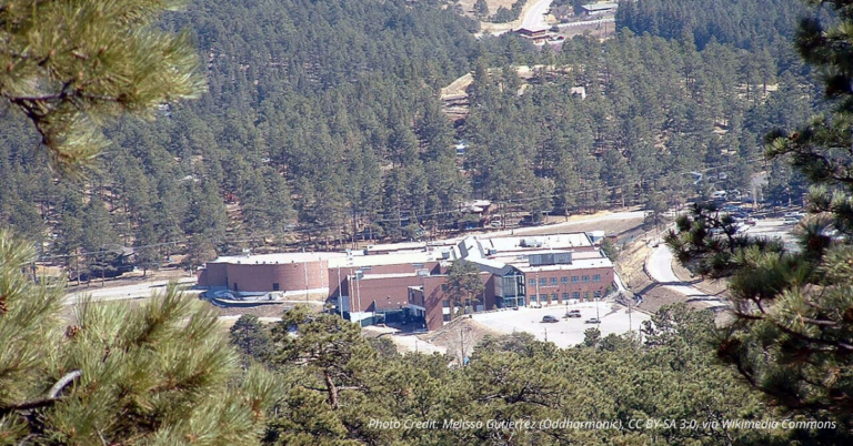 Evergreen High School surrounded by forested hills in Colorado