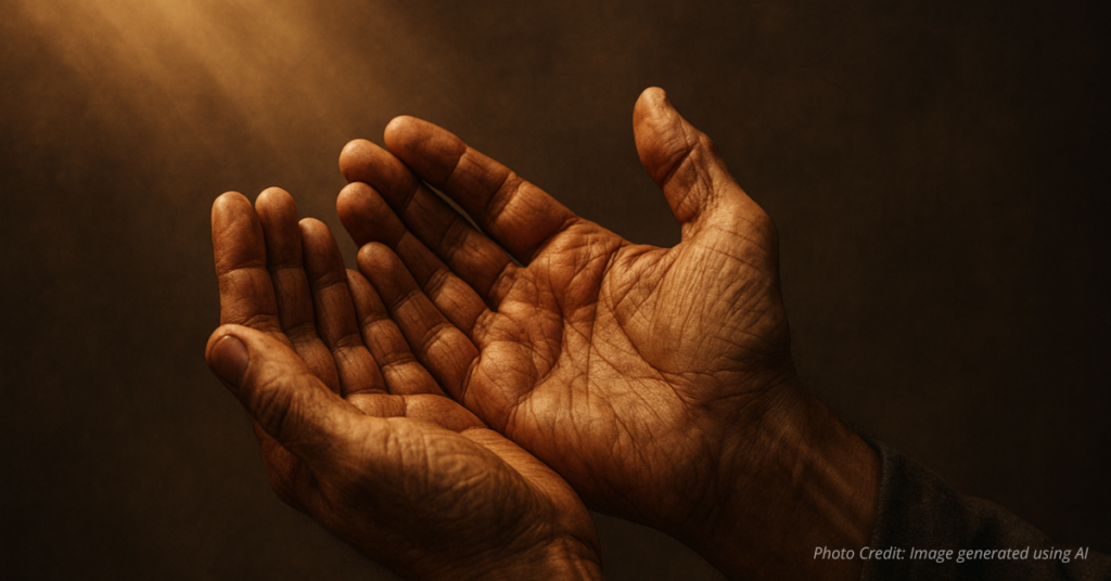 Open hands lifted upward, symbolizing humility in prayer