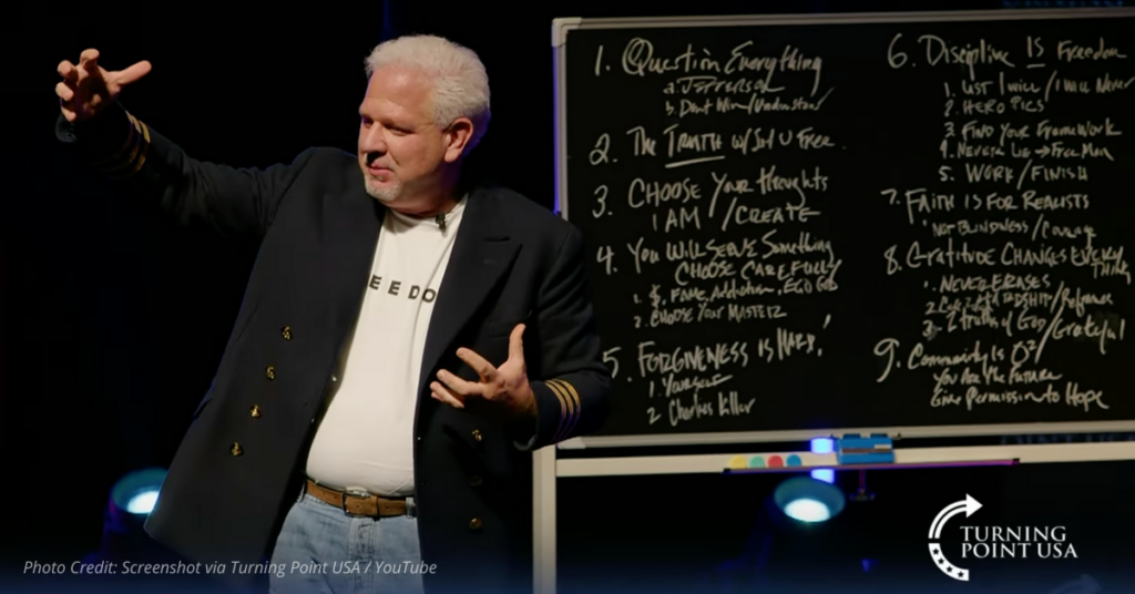 Glenn Beck stands beside a chalkboard listing nine transformative truths during Turning Point USA's North Dakota tour stop