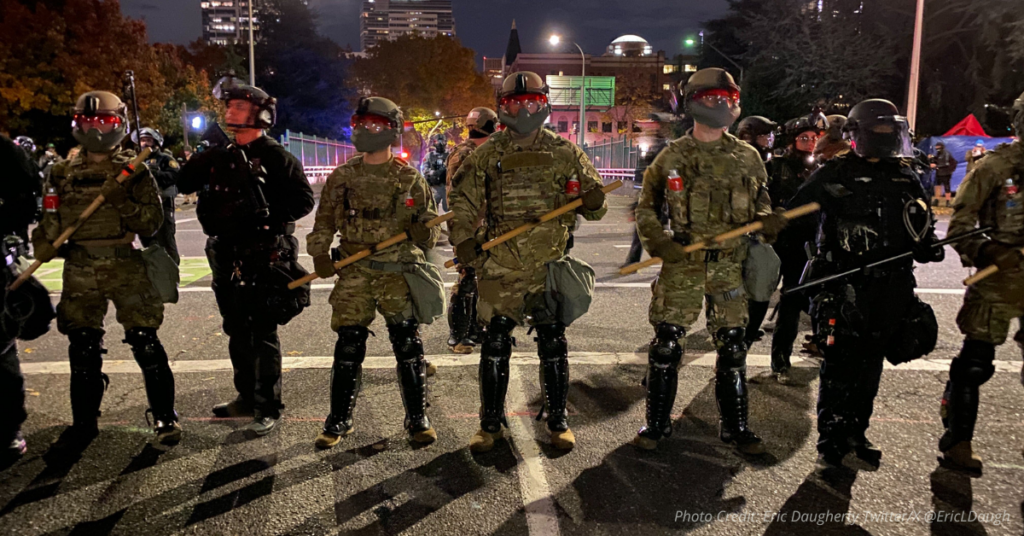 National Guard and federal officers stand in formation in Portland following court ruling