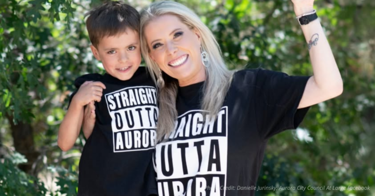 Danielle Jurinsky smiling with her young son wearing matching “Straight Outta Aurora” shirts