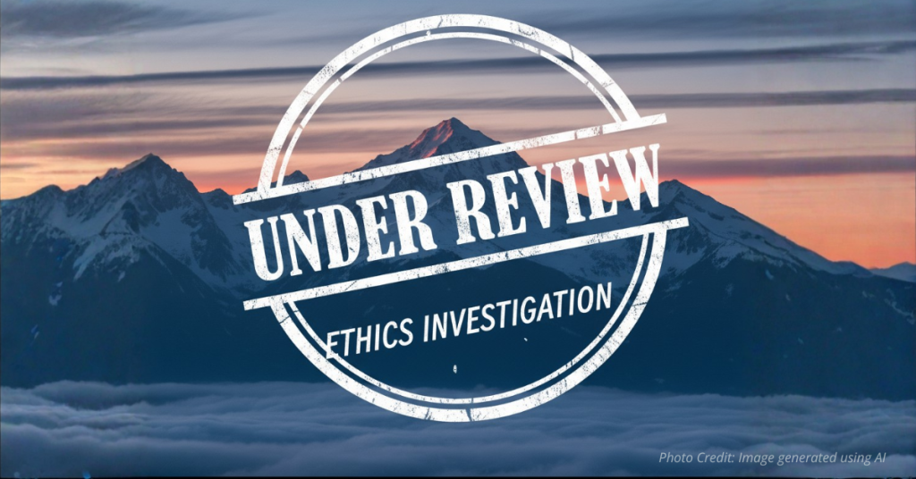 Vail Mountain Range overlaid with "under review" ethics investigation stamp.