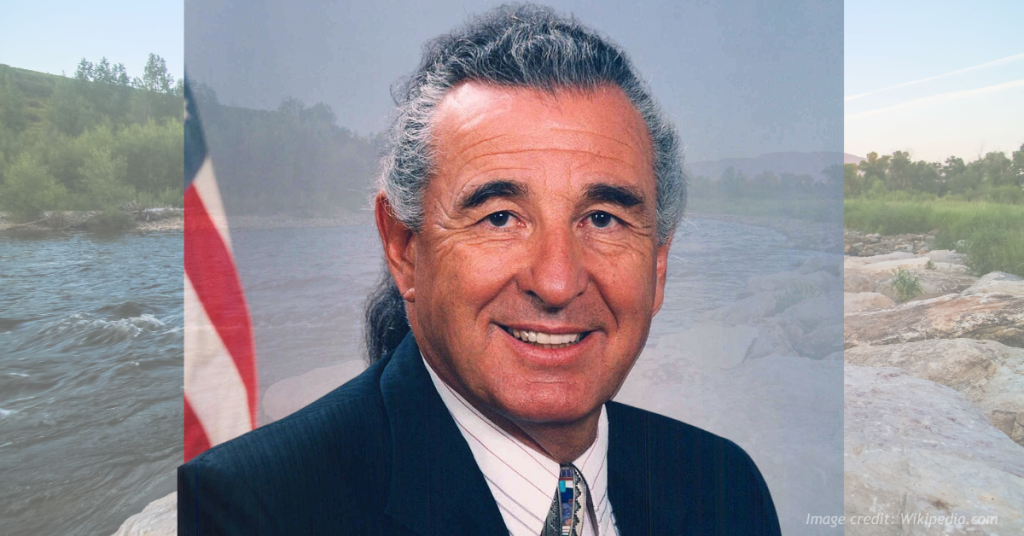 Man in suit near river background Ben Nighthorse Campbell. Office image.