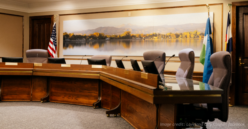 Image of an empty Loveland City Council chamber.