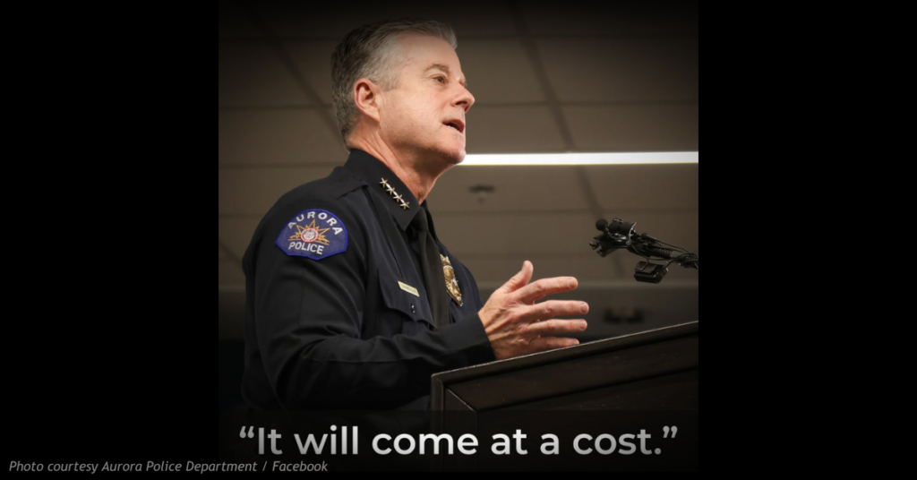 Aurora Police Chief Todd Chamberlain speaks at a podium following an Aurora City Council vote on an immigration resolution