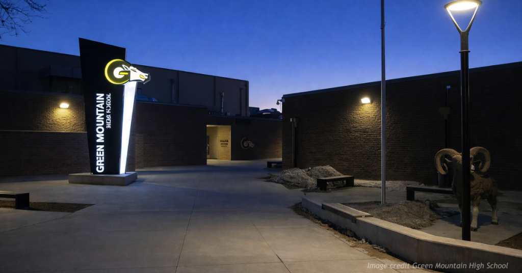 Evening exterior view of Green Mountain High School in Golden Colorado with campus lighting and empty walkways.