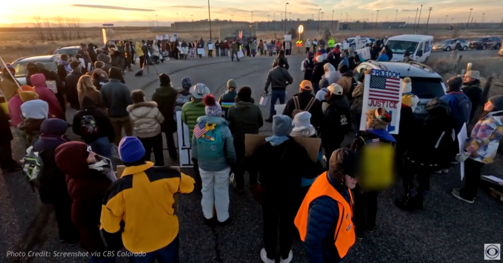 Protesters hold signs outside the Hudson Correctional Facility during a demonstration against an ICE detention proposal.