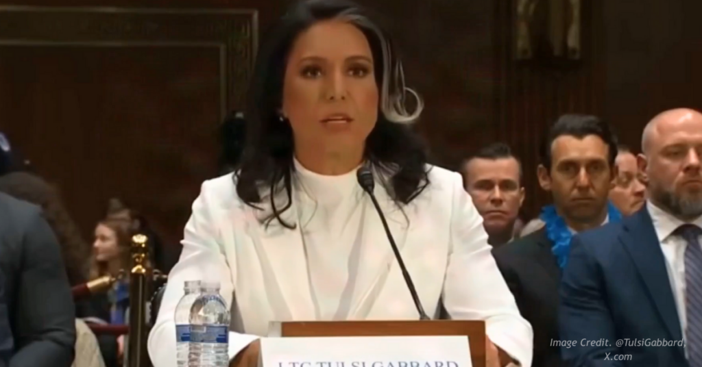 Tulsi Gabbard in her white suit speaking before Congress.