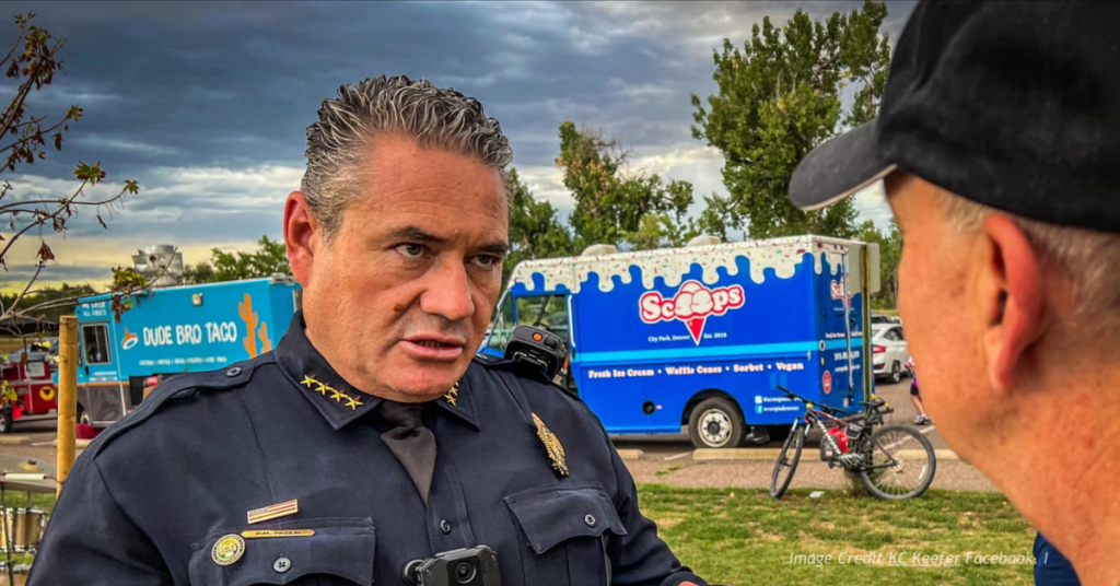 Denver Police Chief Paul Pazen speaks with concerned citizen at park.
