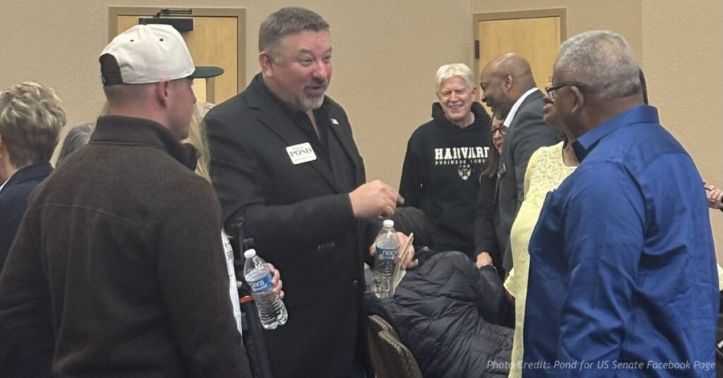 Sean Pond speaks with attendees at an indoor campaign event during his U.S. Senate run.