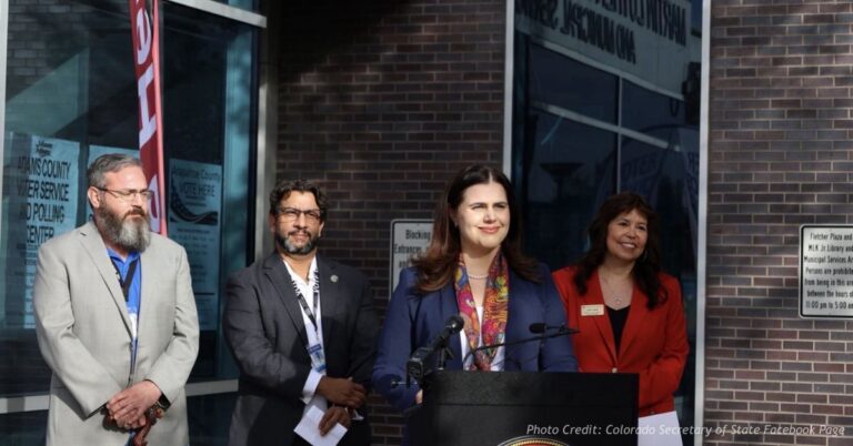 Jena Griswold speaks at a Colorado press conference with officials standing behind her