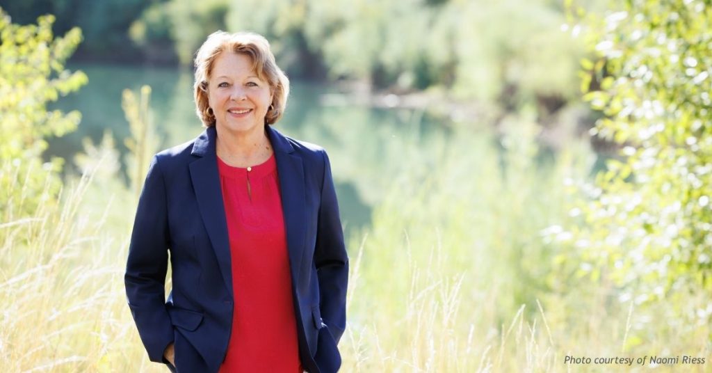 Naomi Riess, Republican candidate for Colorado House District 59, standing outdoors by a river